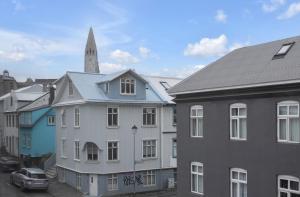 a group of buildings with a church tower in the background at GreenKey Apartment V13 in Reykjavík