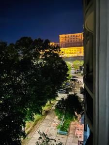 a view of a city with a building and trees at CHIC Apartment Piata Constitutiei - view from the balcony to the Palace of Parliament in Bucharest