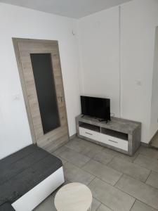 Habitación con cama y mesa con TV. en Počitniška hiša Patrik, en Tolmin