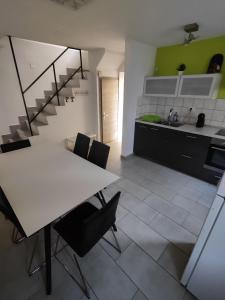 a kitchen with a table and chairs and a staircase at Počitniška hiša Patrik in Tolmin