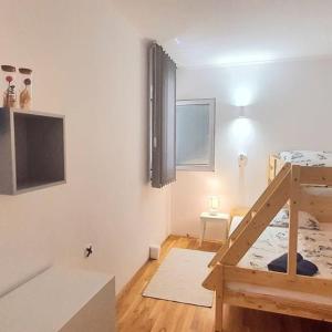 a bedroom with a bed and a tv on the wall at AURELIO in Rijeka