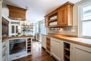 a kitchen with wooden cabinets and a wooden counter top at Pass the Keys Williams Nest Period Dartmoor Apartment in stunning town setting in Newton Abbot