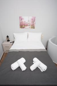 a bedroom with a bed with two towels on it at Lux Aprt in a Graphical Village in Kerásia