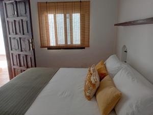 a bedroom with a bed with white sheets and pillows at Casa Mocan in Arrecife