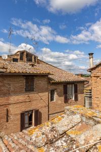 a large brick building with a roof at Il Nido in Buonconvento
