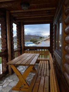 a wooden picnic table on the porch of a cabin at LogCabin Žabljak in Žabljak