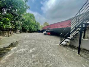 a parking lot with a car parked next to a building at Indochina Airport Hotel in Noi Bai