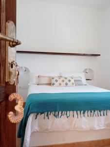 1 dormitorio con cama blanca y manta azul en Casa Mocan, en Arrecife 44 fotos más