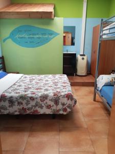 a bedroom with a bed with a dolphin on the wall at Albergue Kortarixar in Elizondo