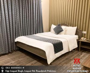 a bed in a hotel room with at Hotel Akbar International in Rawalpindi