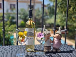 a bottle of wine and two glasses on a table at Apartamento EL PATIO V in Denia