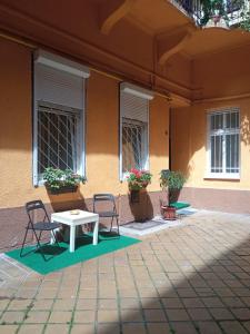 a table and two chairs in front of a building at FREE GARAGE! Downtown apartment, near to Andrássy avenue in Budapest