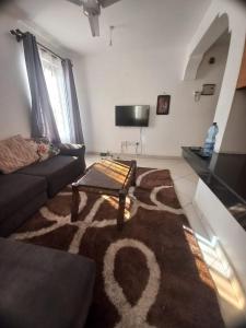 a living room with a couch and a coffee table at Lux suites Startup Apartments in Mombasa