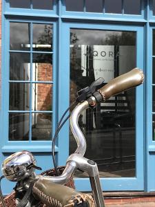 a handlebar of a motorcycle in front of a window at West Street Mews - Serviced Accommodation in Exeter