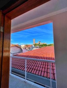 a view of a tile roof from a balcony at Hotel Pousada Dona Ana in Aparecida