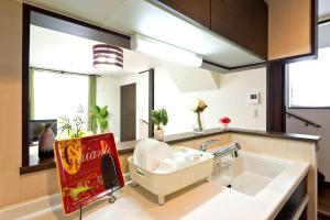 a kitchen with a cocacola cola sign next to a sink at 新宿顶级奢华三层独栋别墅/车站5分钟/儿童房/8人 in Tokyo +34 photos