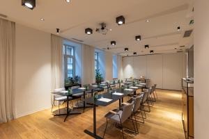 a room with a long table and chairs in it at Boutique Hotel Museum in Belgrade