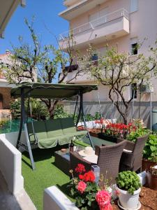 a hammock in a garden with flowers and plants at Apartment Mara in Dubrovnik