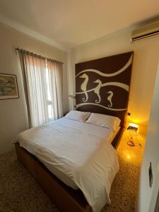 a bedroom with a large bed with a large headboard at Locanda Lorena in Portovenere