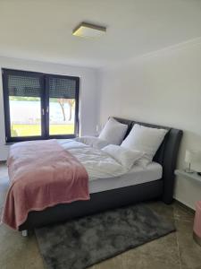 a bedroom with a large bed with a window at Ferienhaus am Lanzer See in Lanze