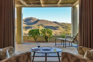 a living room with a view of a mountain at Sanbona Wildlife Reserve in Barrydale