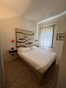 Postel nebo postele na pokoji v ubytování Locanda Lorena