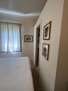 Postel nebo postele na pokoji v ubytování Locanda Lorena
