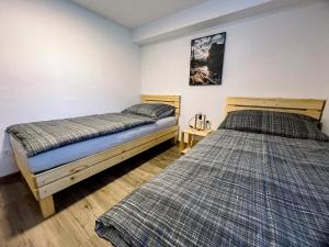 two beds sitting in a room with at Apartment Neli in Rečica ob Savinji