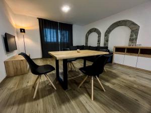 a dining room with a wooden table and chairs at Apartment Neli in Rečica ob Savinji