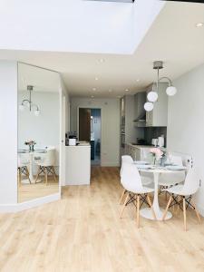 a kitchen and dining room with a table and chairs at 'The Limes' - Air-Con Two Double Bedroom Holiday House with Private Garden in Kent