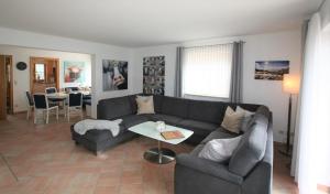 a living room with a couch and a table at Alpenflair Ferienwohnungen Whg 404 in Oberstdorf