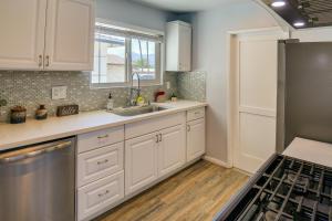 a kitchen with white cabinets and a sink at Palm Desert Vacation Rental with Private Pool and Spa! in Palm Desert