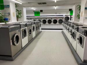 a laundry room with multiple washing machines in it at Destination Family Hotel in Whitehorse