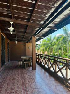 a porch of a house with a table and a bridge at Cabin Hideaway, Alfonso Tagaytay in Alfonso