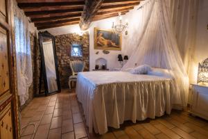 a bedroom with a bed with a mosquito net at Il Casale La Duchessa in Vetulonia
