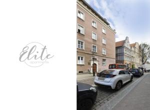 a city street with cars parked on the street at Elite Apartments Hamptons Old Town in Gdańsk