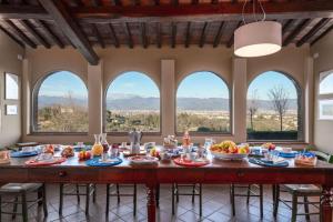 a large dining room with a table with food on it at Villa Bellostare by PosarelliVillas in Cantagrillo