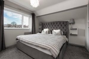 a bedroom with a large bed with a large window at City home with parking and garden- pet friendly in Chester