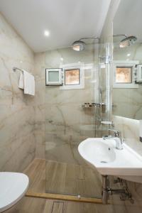 a bathroom with a sink and a shower at gdk house in the heart of Aegina in Aegina Town