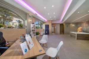 a lobby with a table and chairs and a tub at Kalyves Beach Hotel in Kalyves +130 photos