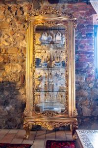 a gold display cabinet in a stone wall at Il Casale La Duchessa in Vetulonia