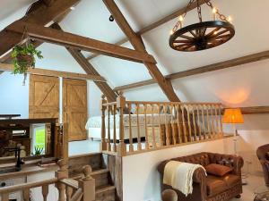 a living room with a vaulted ceiling with wooden beams at B&B droom in de polder -DE SALON- luxe appartement met prive-sauna in Arnemuiden
