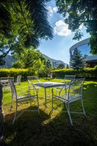 four chairs and a table in the grass at Spectrum Resort & Spa in Udaipur