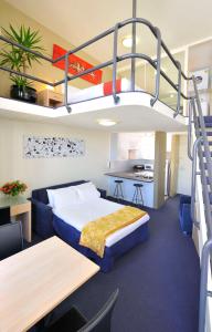 a hotel room with a bunk bed and a kitchen at Metro Apartments On Darling Harbour in Sydney