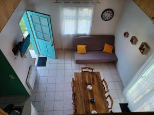 a small room with a table and a couch at La Maison Bleu du Lac de Céline in Giffaumont-Champaubert