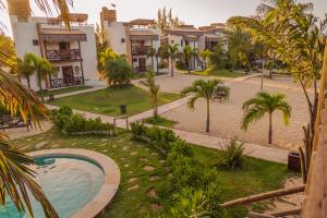 a resort with a swimming pool and palm trees at Moriá Eco Lodge in Icaraí