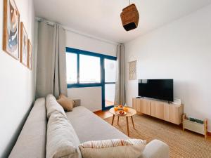 a living room with a couch and a tv at Casa Bezunia, Costa Calma in Costa Calma