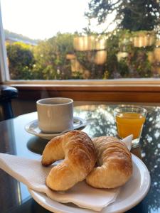 two croissants sitting on a plate on a table at Hotel Crismalu in San Martín de los Andes
