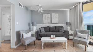 a living room with a couch and two chairs at Sunbird Sunsets in Panama City Beach