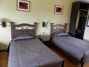 Cama o camas de una habitación en La Posada del Conde Lodge